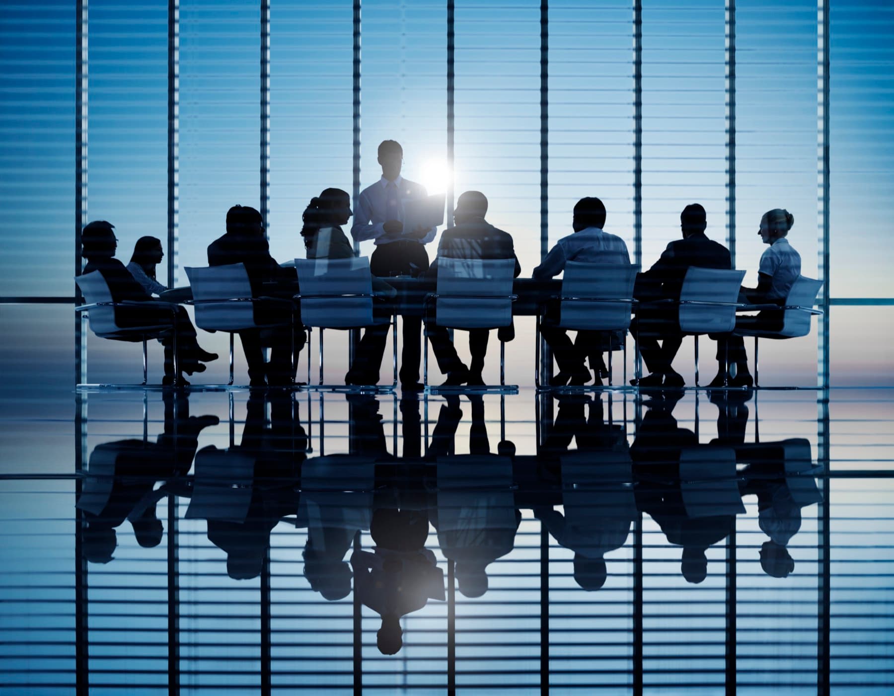 Colleagues meeting in a modern glass office